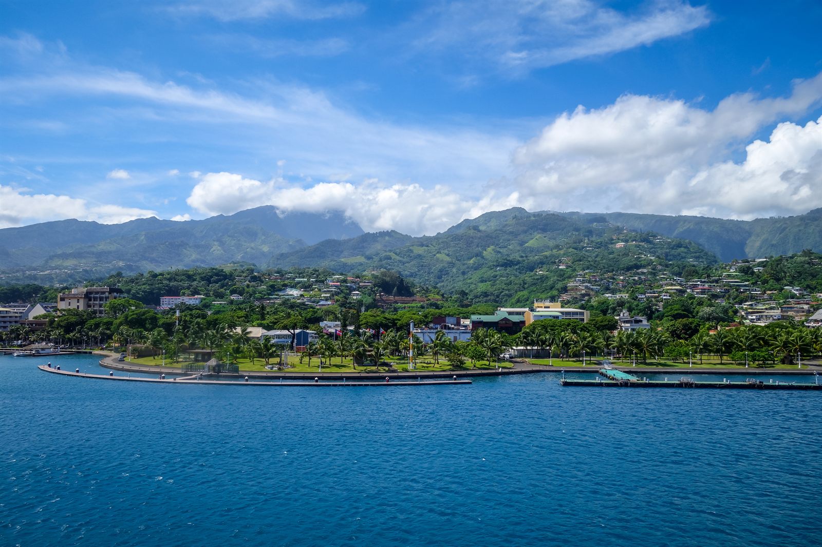 Green mountains and a sheltered blue bay on a South Pacific island